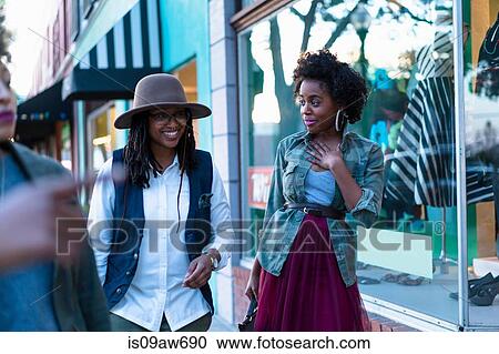 Group of female friends, window shopping View Large Photo Image Stock Image - Group of female friends, window shopping. Fotosearch