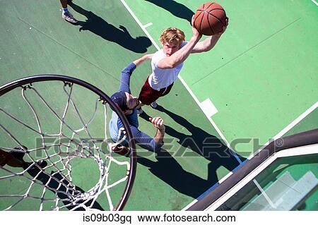 Group of male friends playing basketball on outdoor court, elevated view View Large Photo Image Stock Photography - Group of male friends playing basketball on outdoor court, elevated view. Fotosearch