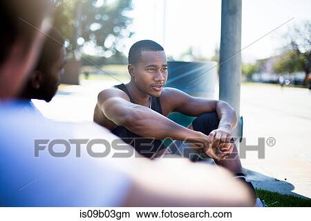 Group of male friends sitting together in park View Large Photo Image Picture - Group of male friends sitting together in park. Fotosearch