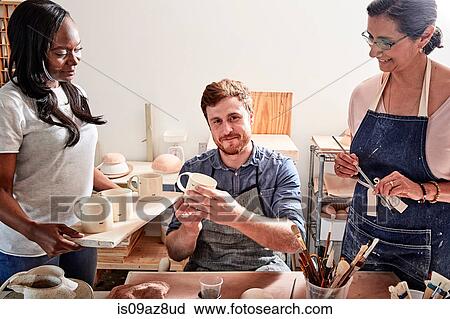 Group of people painting pottery in workshop View Large Photo Image Stock Image - Group of people painting pottery in workshop. Fotosearch