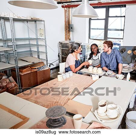 Group of people painting pottery in workshop View Large Photo Image Stock Image - Group of people painting pottery in workshop. Fotosearch