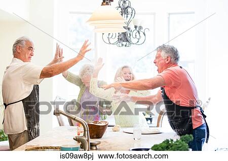Group of seniors having fun in kitchen View Large Photo Image Stock Image - Group of seniors having fun in kitchen. Fotosearch