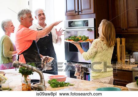 Group of seniors preparing meal in kitchen View Large Photo Image Stock Image - Group of seniors preparing meal in kitchen. Fotosearch