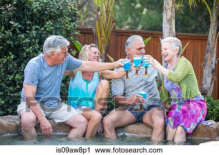 Group of seniors toasting at pool View Large Photo Image Stock Image - Group of seniors toasting at pool. Fotosearch