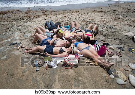 Group of young women sunbathing on beach, Block Island, Rhode Island, USA View Large Photo Image Stock Photography - Group of young women sunbathing on beach, Block Island, Rhode Island, USA. Fotosearch