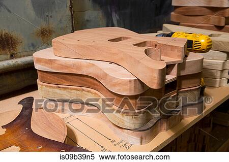 Stock Photography - Guitar bodies stacked in workshop. Fotosearch