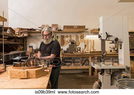 Guitar maker in workshop manufacturing guitar View Large Photo Image Stock Image - Guitar maker in workshop manufacturing guitar. Fotosearch