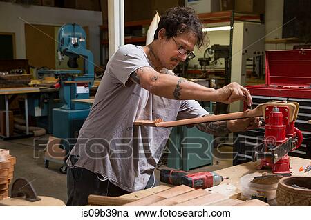 Guitar maker in workshop manufacturing guitar View Large Photo Image Stock Image - Guitar maker in workshop manufacturing guitar. Fotosearch