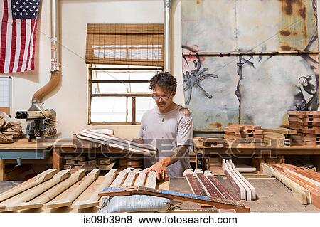 Guitar maker in workshop manufacturing guitar View Large Photo Image Stock Photo - Guitar maker in workshop manufacturing guitar. Fotosearch
