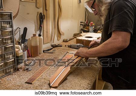 Guitar maker in workshop manufacturing guitar View Large Photo Image Stock Photography - Guitar maker in workshop manufacturing guitar. Fotosearch
