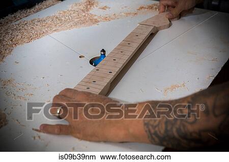 Guitar maker manufacturing guitar in workshop View Large Photo Image Picture - Guitar maker manufacturing guitar in workshop. Fotosearch