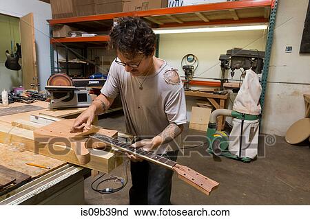 Guitar maker manufacturing guitar in workshop View Large Photo Image Stock Image - Guitar maker manufacturing guitar in workshop. Fotosearch