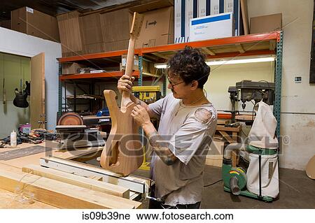 Guitar maker manufacturing guitar in workshop View Large Photo Image Stock Image - Guitar maker manufacturing guitar in workshop. Fotosearch