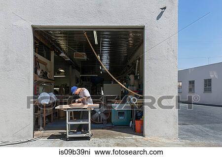 Guitar maker manufacturing guitar outside workshop View Large Photo Image Stock Image - Guitar maker manufacturing guitar outside workshop. Fotosearch