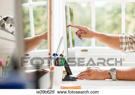 Hand of male designer pointing at desktop computer in creative studio View Large Photo Image Stock Image - Hand of male designer pointing at desktop computer in creative studio. Fotosearch