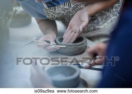 Hands of female potters shaping clay pots in workshop View Large Photo Image Stock Image - Hands of female potters shaping clay pots in workshop. Fotosearch