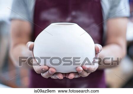 Hands of male potter holding finished vase in workshop View Large Photo Image Picture - Hands of male potter holding finished vase in workshop. Fotosearch