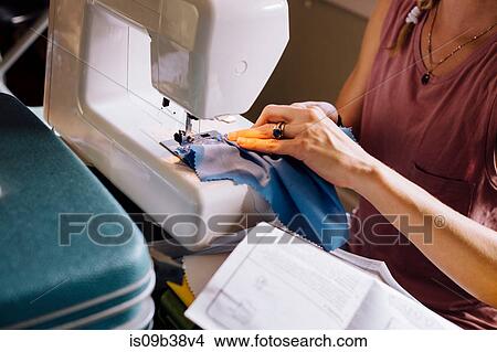 Hands of woman sewing on sewing machine View Large Photo Image Picture - Hands of woman sewing on sewing machine. Fotosearch