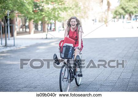 Happy businesswoman freewheeling on bicycle in city View Large Photo Image Stock Photography - Happy businesswoman freewheeling on bicycle in city. Fotosearch