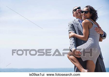 Happy couple hugging outdoors View Large Photo Image Stock Image - Happy couple hugging outdoors. Fotosearch