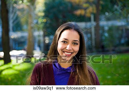 Happy young woman in park View Large Photo Image Stock Image - Happy young woman in park. Fotosearch