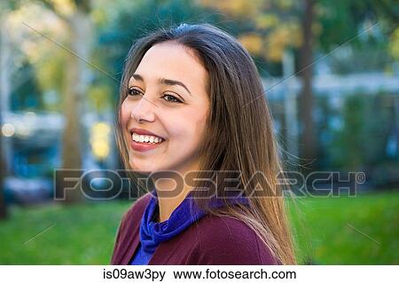 Stock Photo - Happy young woman in park. Fotosearch