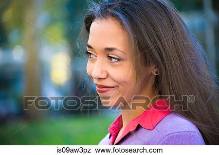 Stock Photo - Happy young woman in park. Fotosearch