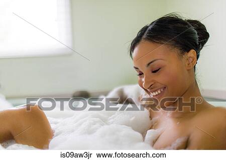 Happy young woman relaxing in bubble bath View Large Photo Image Stock Photography - Happy young woman relaxing in bubble bath. Fotosearch