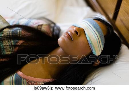 Head and shoulder shot of young woman in bed wearing sleepmask View Large Photo Image Stock Photo - Head and shoulder shot of young woman in bed wearing sleepmask. Fotosearch