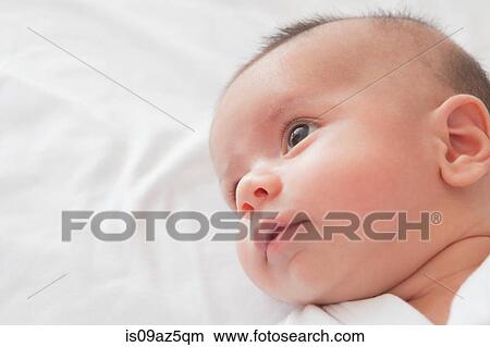 Picture - Head shot of baby boy looking away. Fotosearch