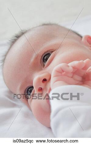 Head shot of baby boy lying down View Large Photo Image Stock Image - Head shot of baby boy lying down. Fotosearch