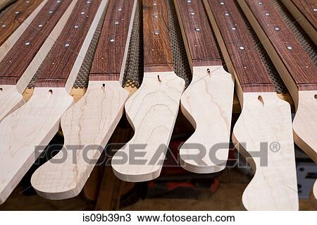 Headstocks and necks of guitars in workshop View Large Photo Image Stock Image - Headstocks and necks of guitars in workshop. Fotosearch