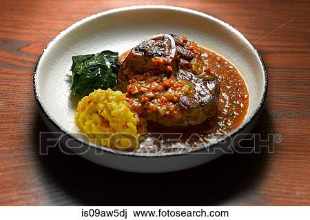High angle view of ossobuco with side dish of vegetables in shallow bowl View Large Photo Image Stock Image - High angle view of ossobuco with side dish of vegetables in shallow bowl. Fotosearch