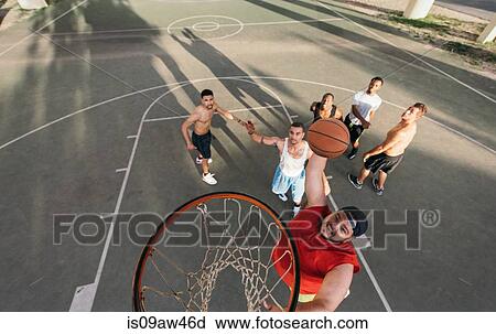 High angle view of young man on basketball court doing slam dunk View Large Photo Image Stock Image - High angle view of young man on basketball court doing slam dunk. Fotosearch