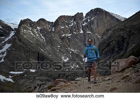 Stock Photo - Hiker exploring Chasm Lake, Rocky Mountains National Park, Colorado. Fotosearch