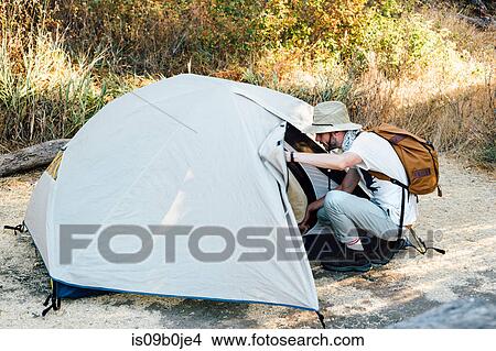 Hiker getting into tent, Malibu Canyon, California, USA View Large Photo Image Picture - Hiker getting into tent, Malibu Canyon, California, USA. Fotosearch