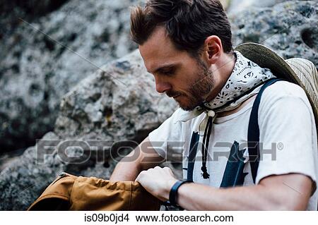 Hiker looking in backpack, Malibu Canyon, California, USA View Large Photo Image Picture - Hiker looking in backpack, Malibu Canyon, California, USA. Fotosearch