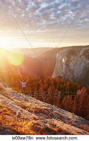 Hiker rejoicing on hill, Yosemite National Park, Sierra Nevada View Large Photo Image Picture - Hiker rejoicing on hill, Yosemite National Park, Sierra Nevada. Fotosearch