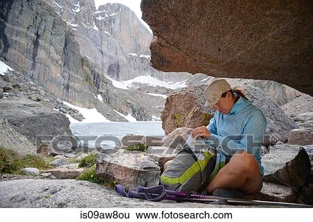 Hiker taking break, Chasm Lake, Rocky Mountains National Park, Colorado View Large Photo Image Stock Photograph - Hiker taking break, Chasm Lake, Rocky Mountains National Park, Colorado. Fotosearch
