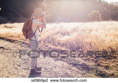 Hiker taking photograph, Malibu Canyon, California, USA View Large Photo Image Stock Image - Hiker taking photograph, Malibu Canyon, California, USA. Fotosearch
