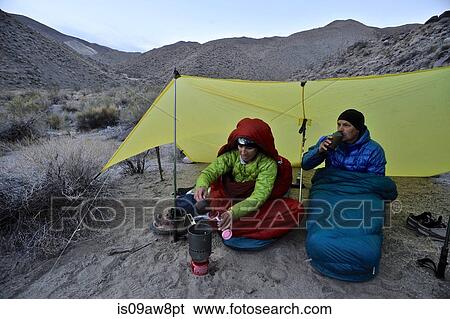 Stock Photograph - Hikers camping in desert, Cottonwood Canyon, Death Valley National Park, California. Fotosearch