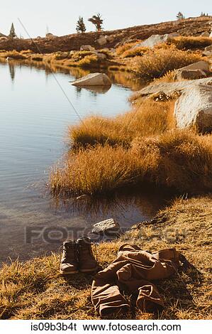 Stock Photograph - Hiking boots and jeans by lakeside, Mineral King, Sequoia National Park, California, USA. Fotosearch