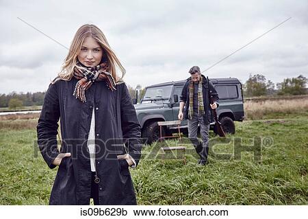 Hunting couple, portrait of young woman in field View Large Photo Image Stock Image - Hunting couple, portrait of young woman in field. Fotosearch