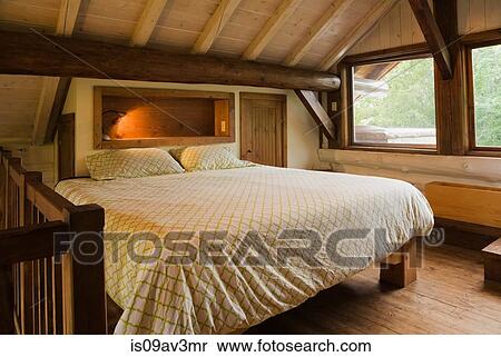 King Size Bed On Wooden Frame In Master Bedroom On The