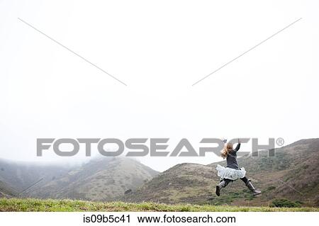 Landscape view of girl in tutu jumping mid air View Large Photo Image Stock Image - Landscape view of girl in tutu jumping mid air. Fotosearch