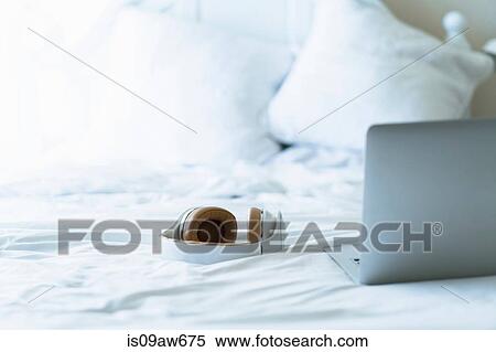 Laptop and headphones on bed, still life View Large Photo Image Stock Photography - Laptop and headphones on bed, still life. Fotosearch