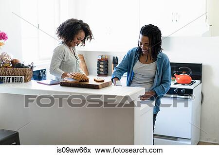 Lesbian couple in kitchen, making breakfast View Large Photo Image Stock Photo - Lesbian couple in kitchen, making breakfast. Fotosearch