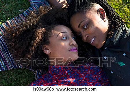 Lesbian couple lying together in park, face to face View Large Photo Image Picture - Lesbian couple lying together in park, face to face. Fotosearch