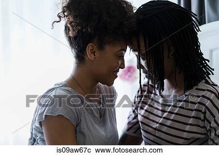 Lesbian couple relaxing in bedroom, face to face View Large Photo Image Stock Image - Lesbian couple relaxing in bedroom, face to face. Fotosearch