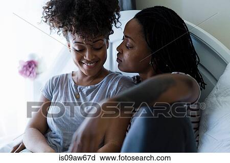 Lesbian couple relaxing on bed View Large Photo Image Stock Image - Lesbian couple relaxing on bed. Fotosearch